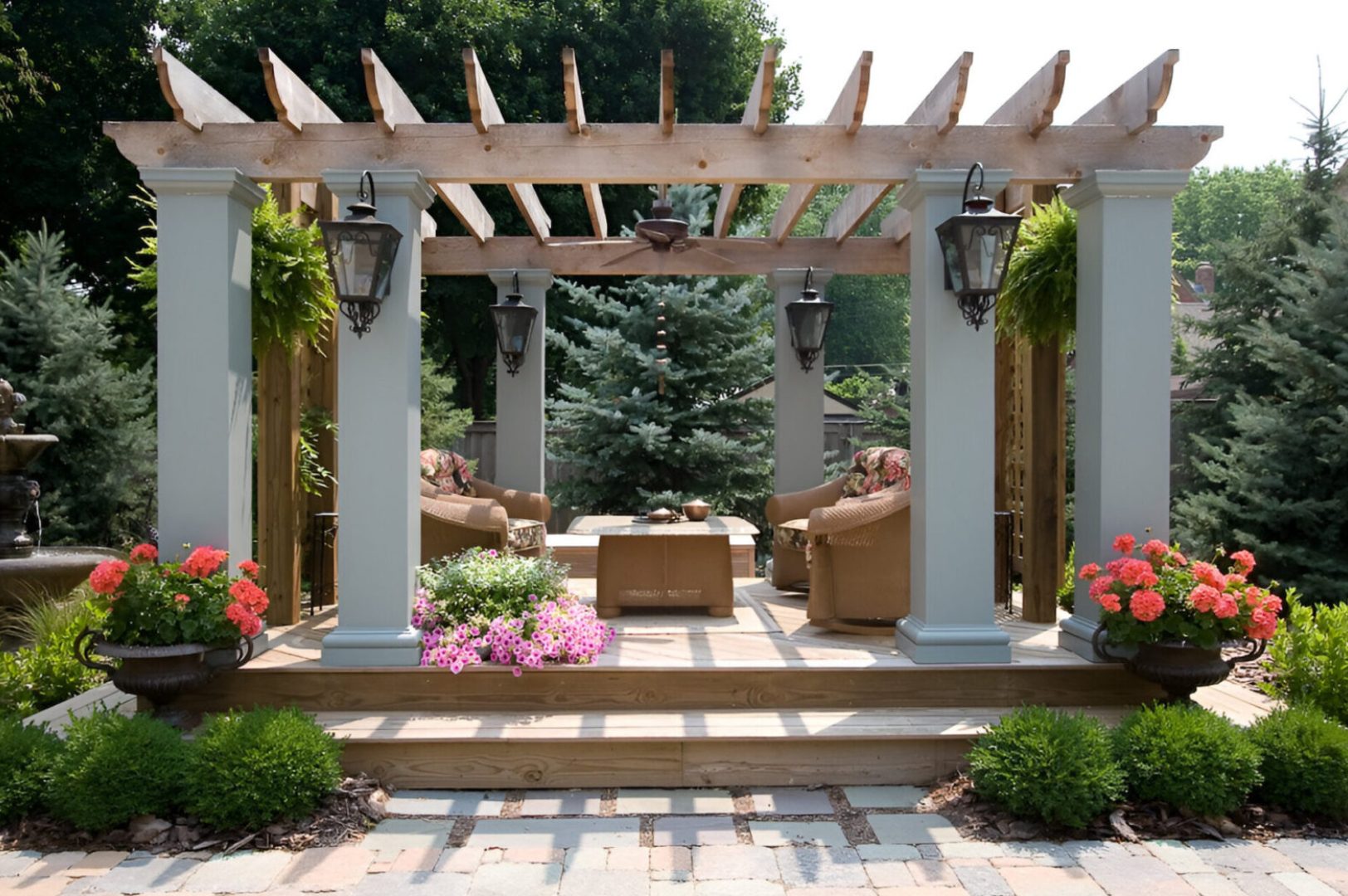 A patio with a pergola and furniture in it