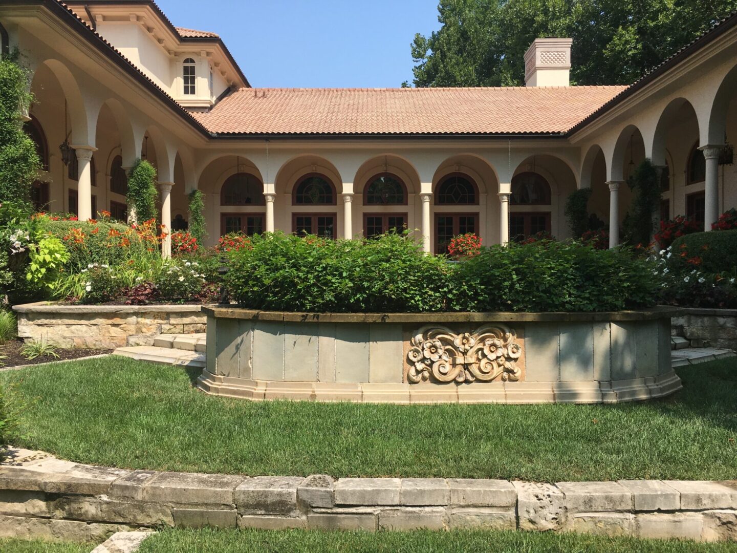Mediterranean-style courtyard with garden and arches.
