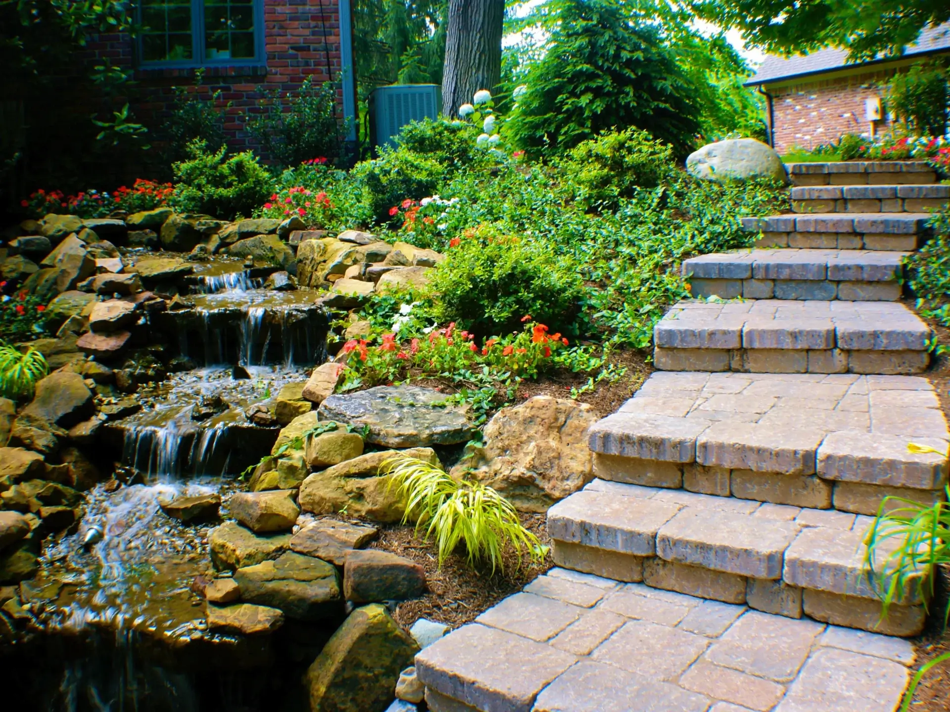 Garden with stone stairs and waterfall.