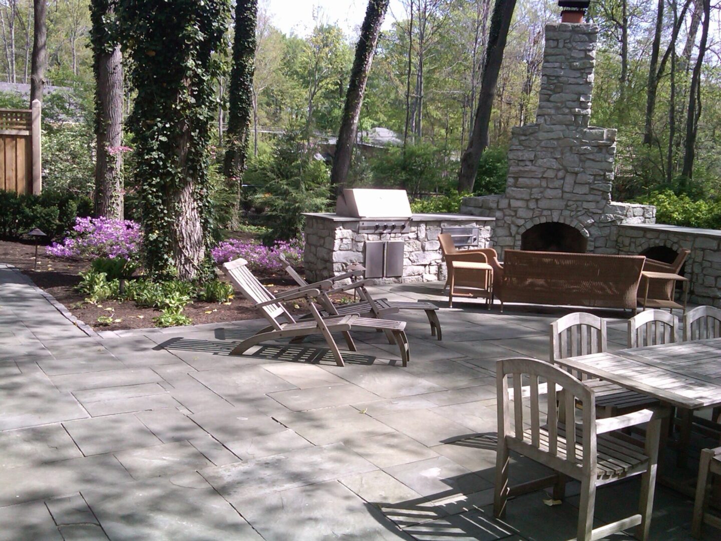 Outdoor patio with fireplace and furniture.