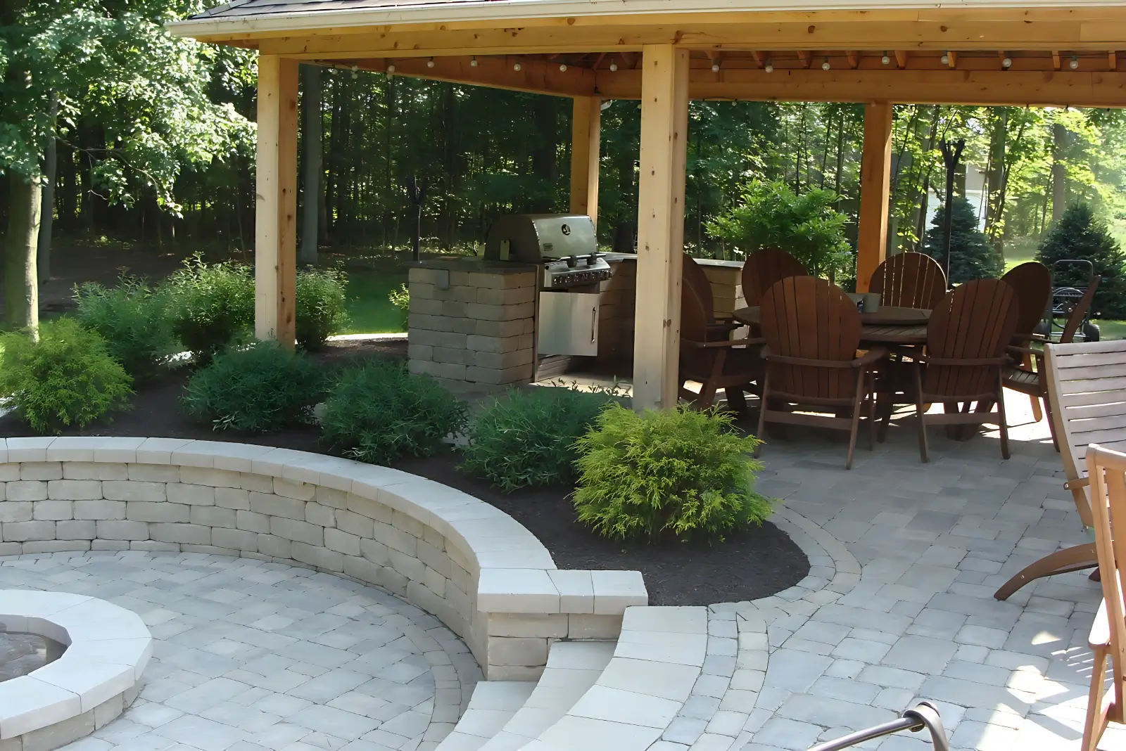 Covered paver patio with grill and chairs
